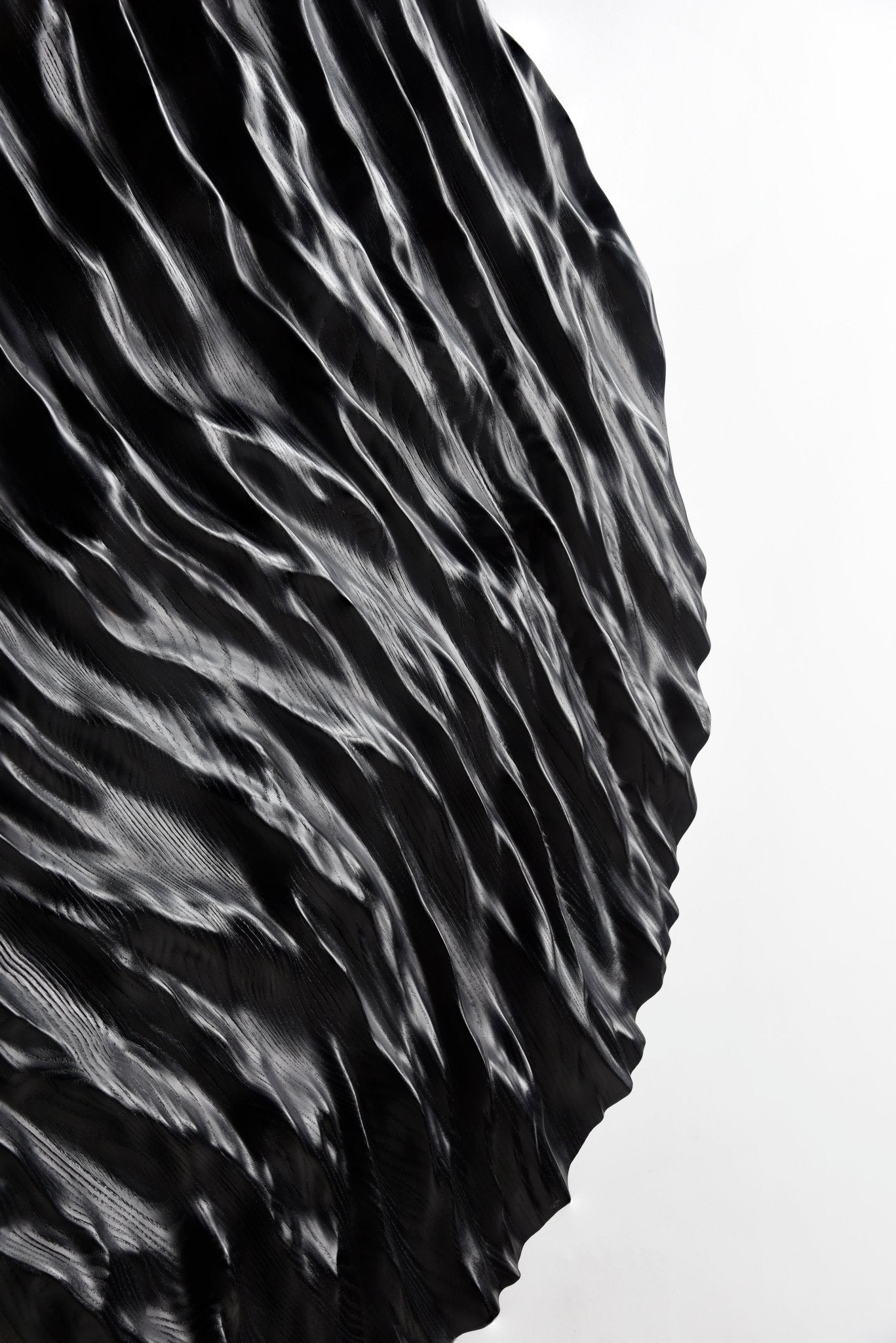 Smooth edge highlighting the black wood’s subdued grain, merging boho chic interior appeal with a crisp geometric design motif.