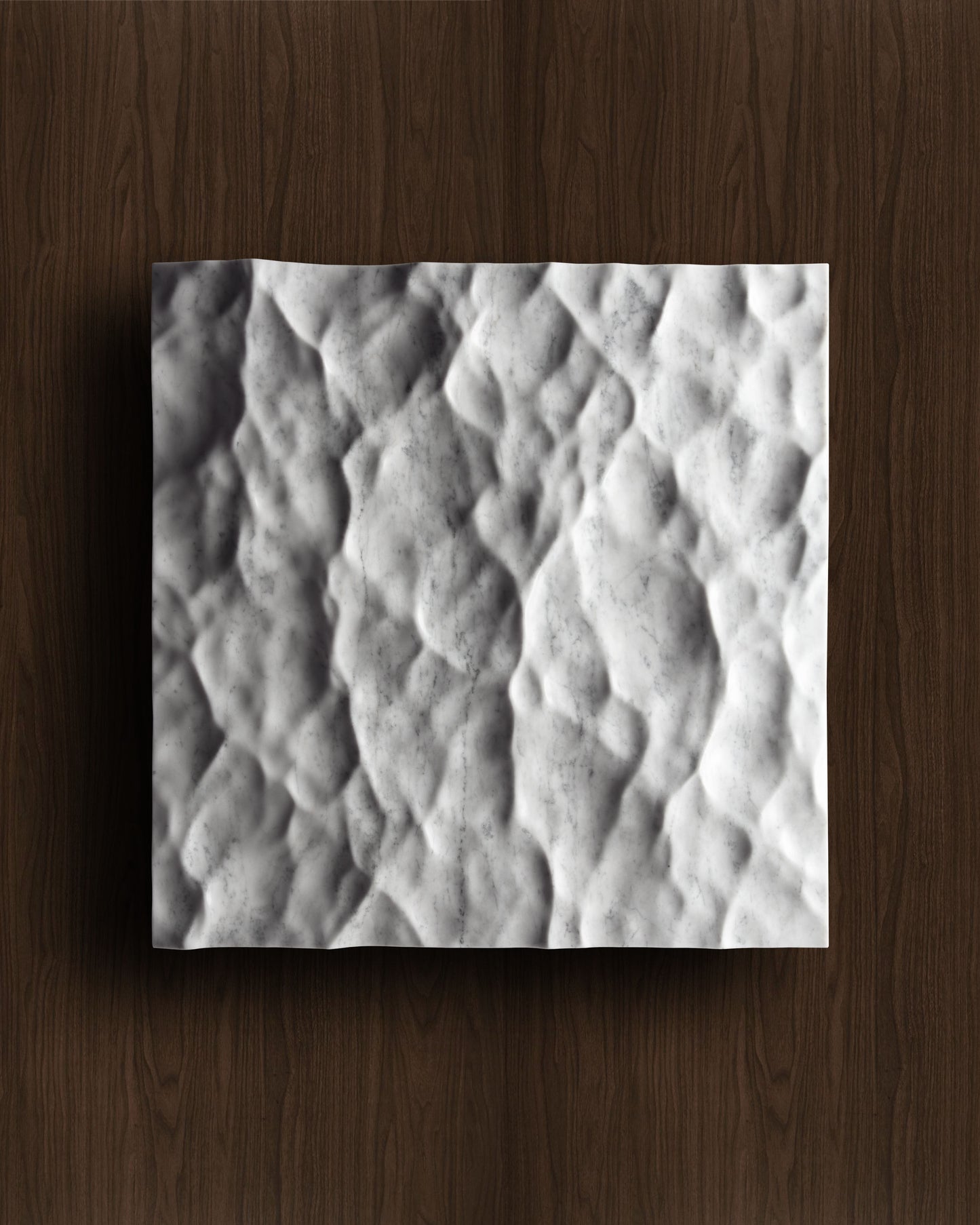 Liquid marble wall sculpture displayed on a warm walnut background