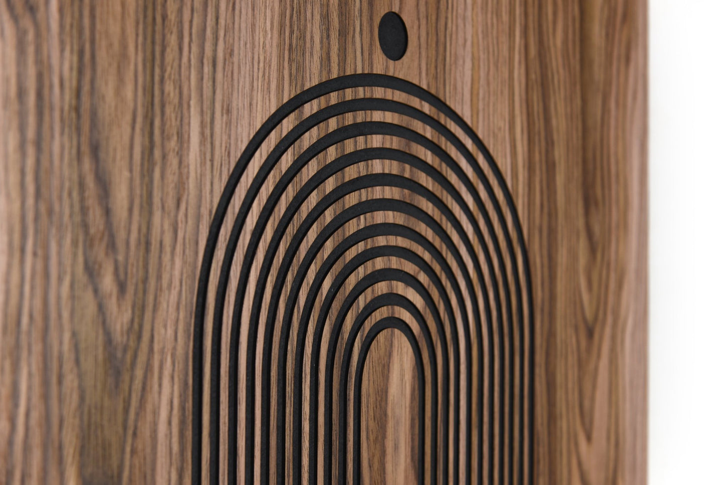 Close up of lower arch relief on walnut, carved lines and black background