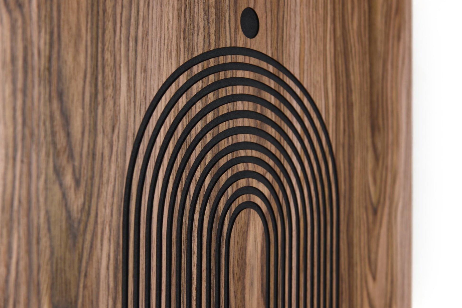 Close up of lower arch relief on walnut, carved lines and black background