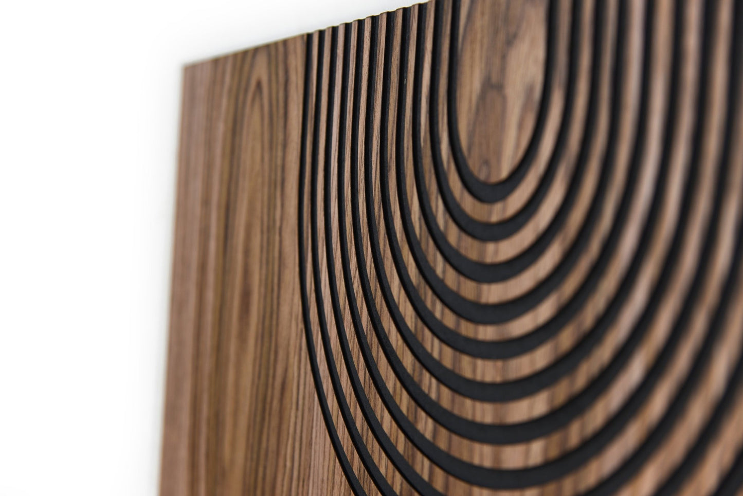 Angled macro of carved arc field, walnut grain and black grooves