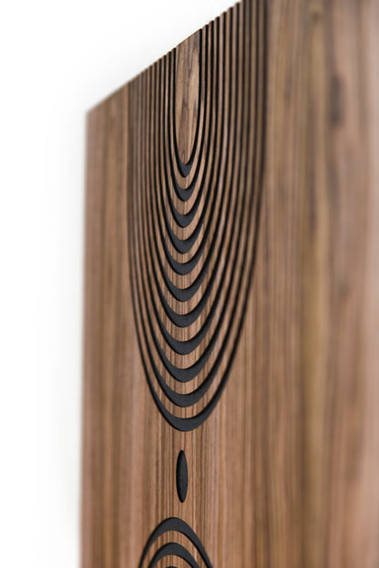 Angled view of the arched line motif carved into walnut with dark inlay