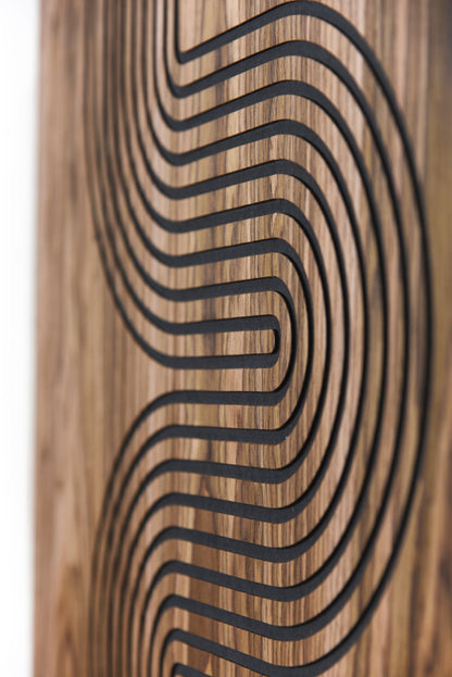 Close up of curved black inlay lines on walnut with visible grain