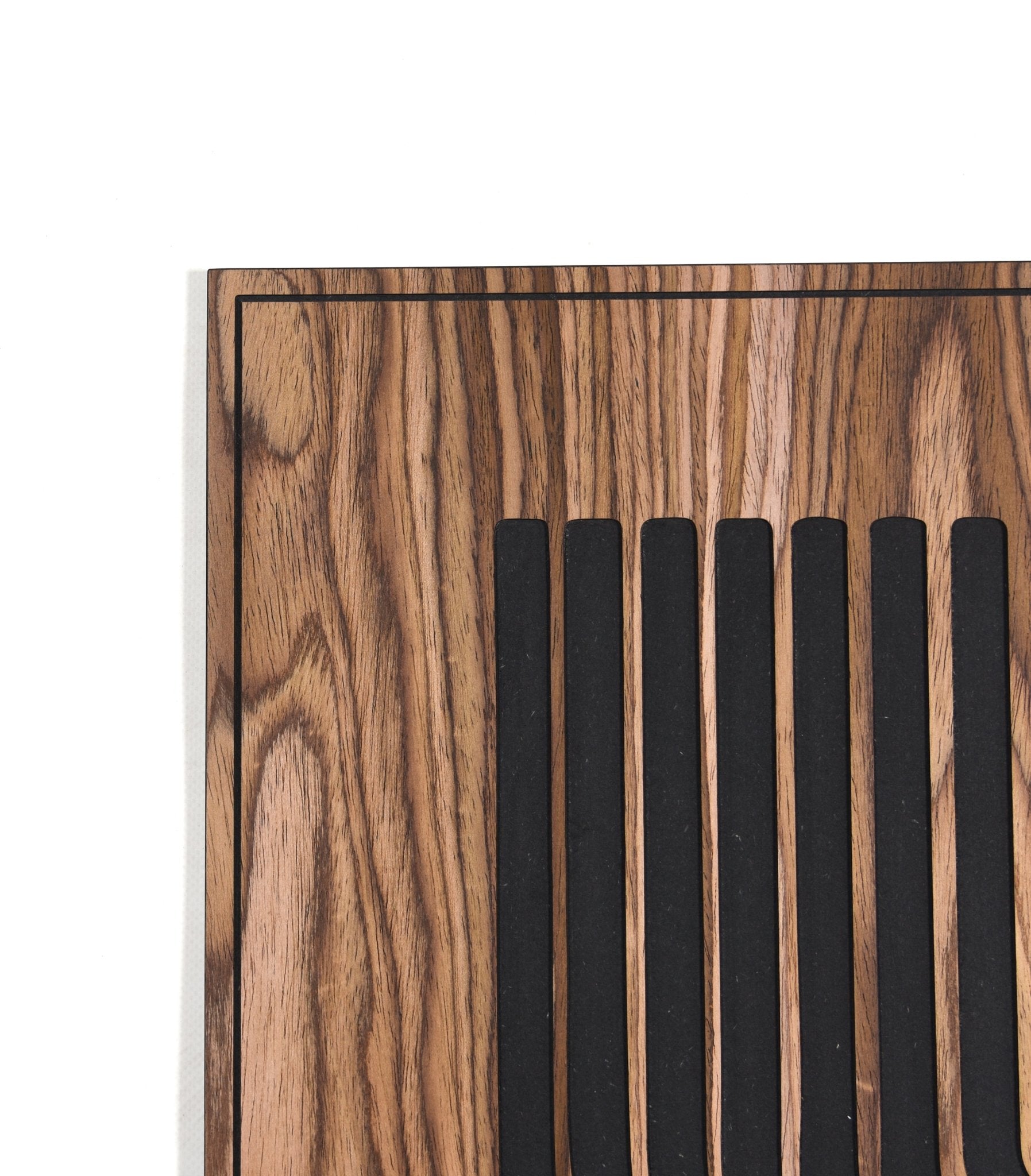 Close up of the curved line pattern with black inlay on walnut