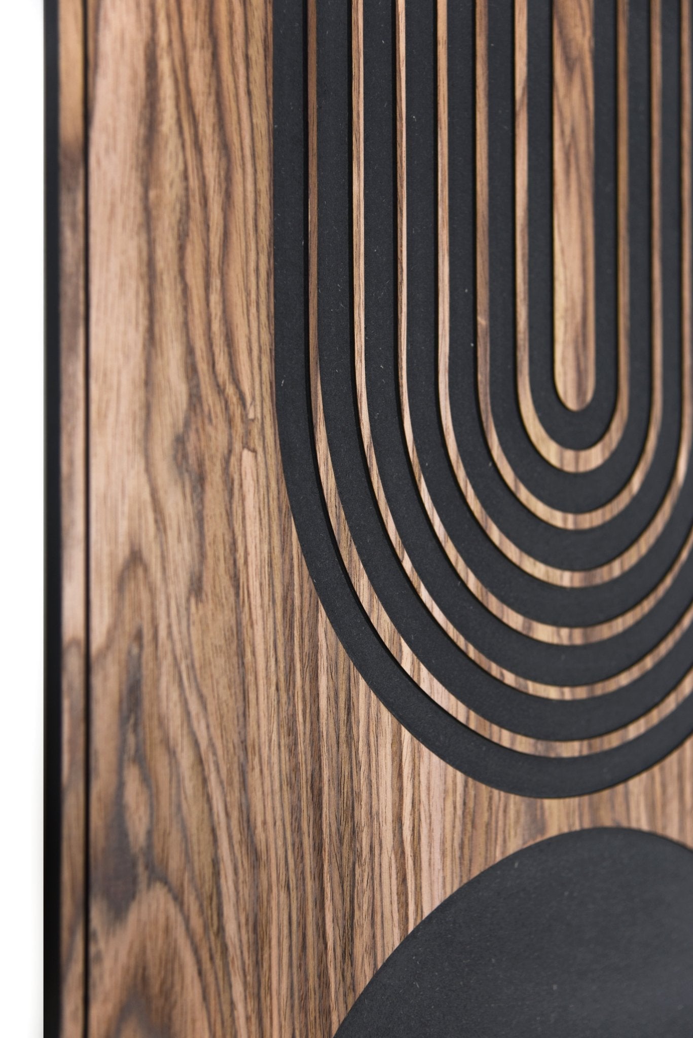 Side close up showing walnut grain and the black inlay surface in perspective