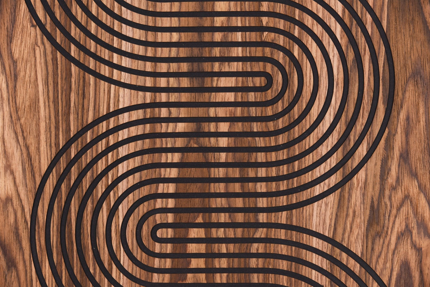 Macro detail of the S curve line pattern in black inlay on walnut