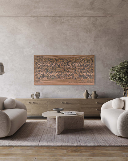 Bubble walnut and black wall panel centered above white sofa, bright interior view
