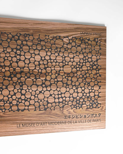 Macro close up of bubble circle relief, walnut grain and black carving
