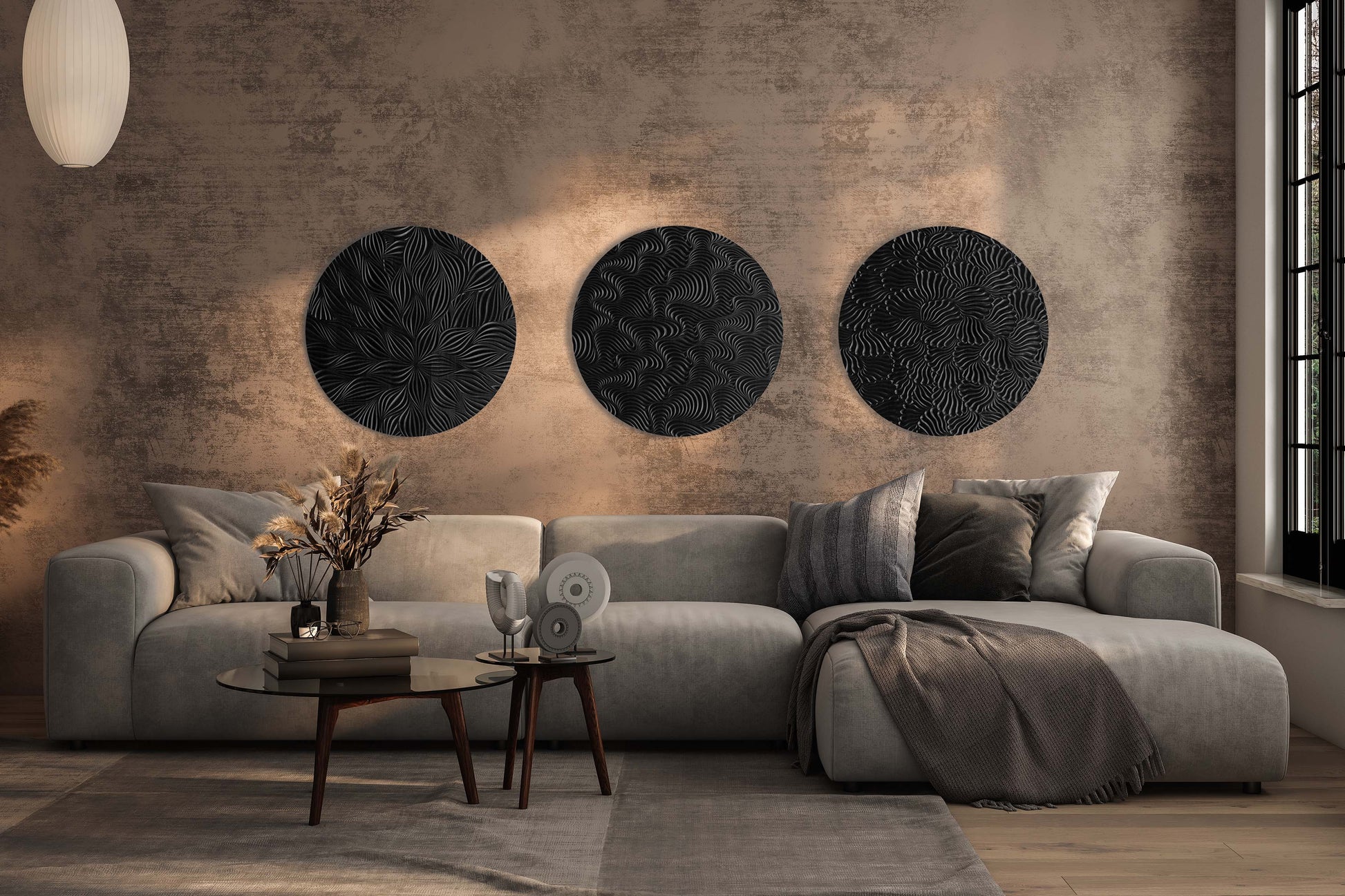 Curated set of three round wall sculptures in iroko and black styled as a gallery composition above a sofa