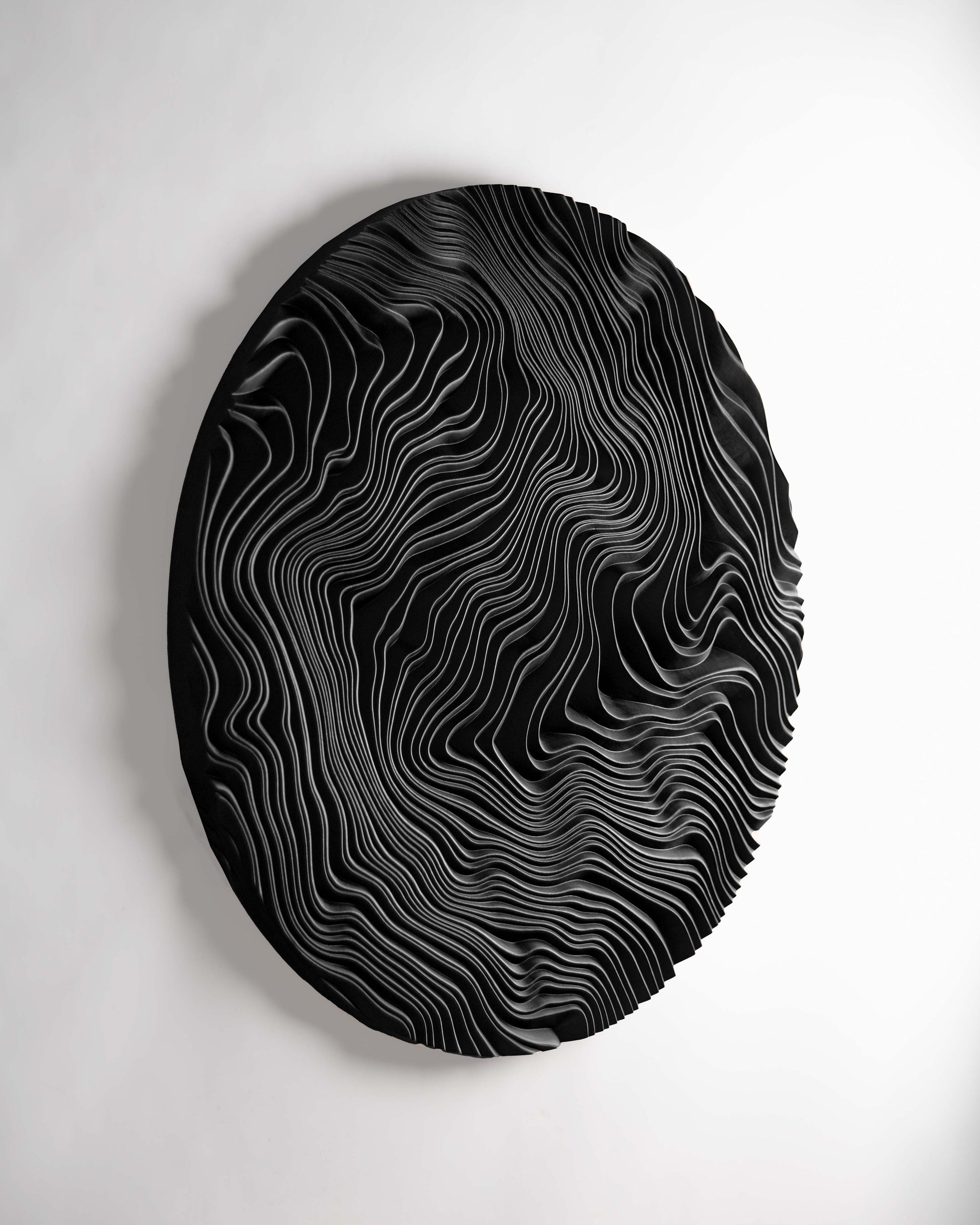 Close perspective on ridges swirling through dark-stained Iroko, merging boho chic interior charm with modern geometric design sensibilities.