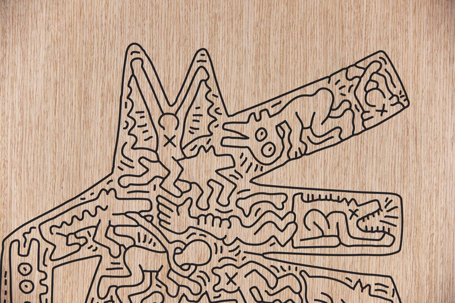 Close up of the carved black line work on the Crocodile Keith Haring oak wall artwork