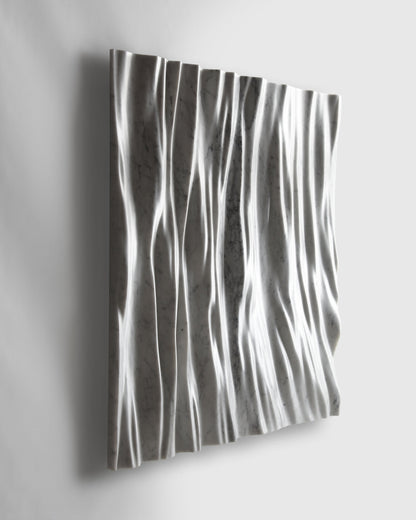 Perspective view of the Eternal marble wall sculpture highlighting relief and shadow movement