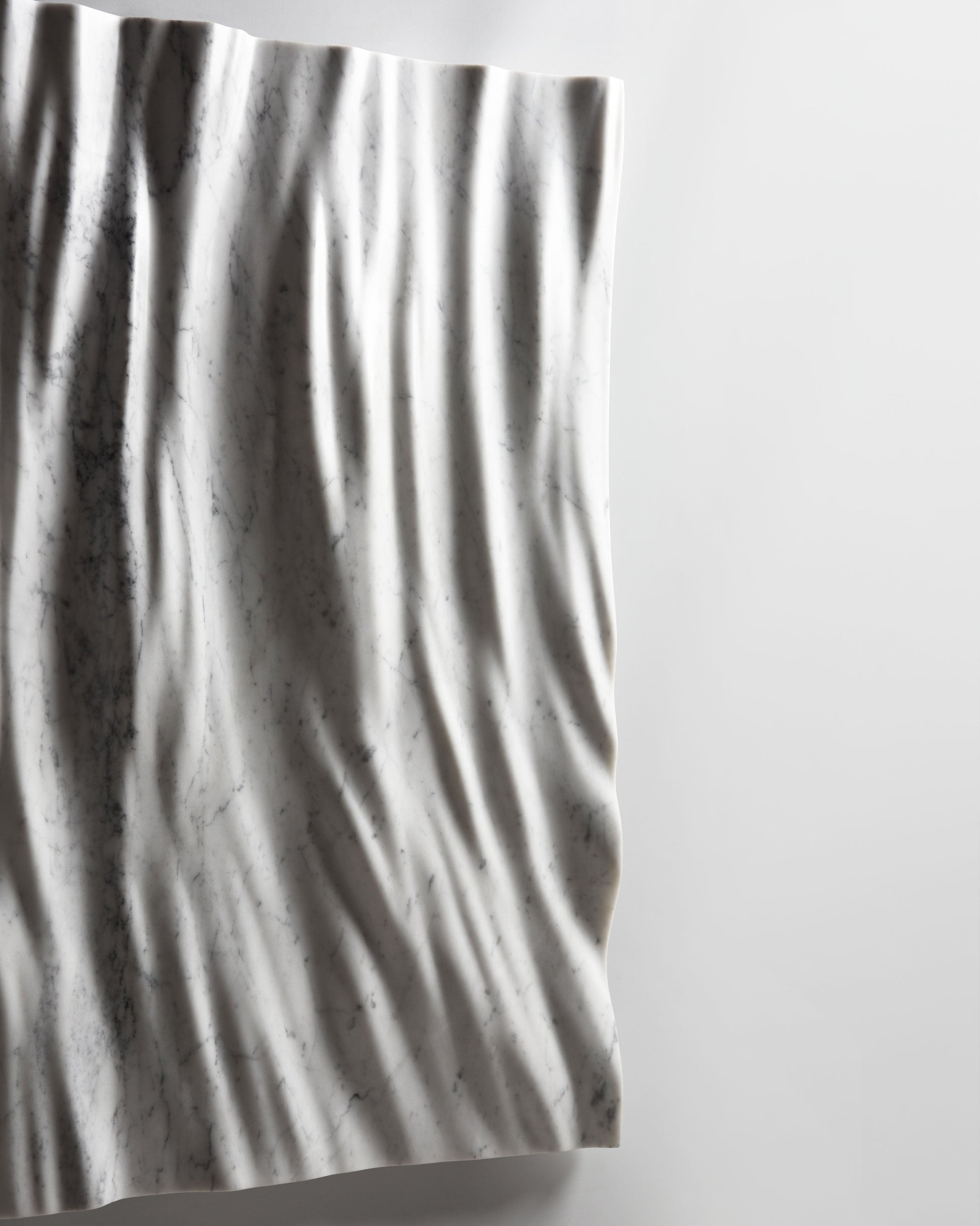 Side detail of the Eternal marble sculpture showing edge depth and sculpted folds