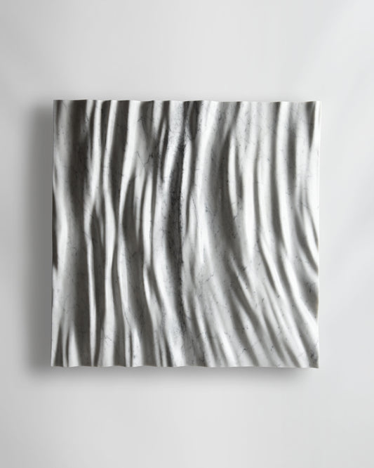 Eternal Carrara marble wall sculpture front view with flowing vertical folds and natural grey veining