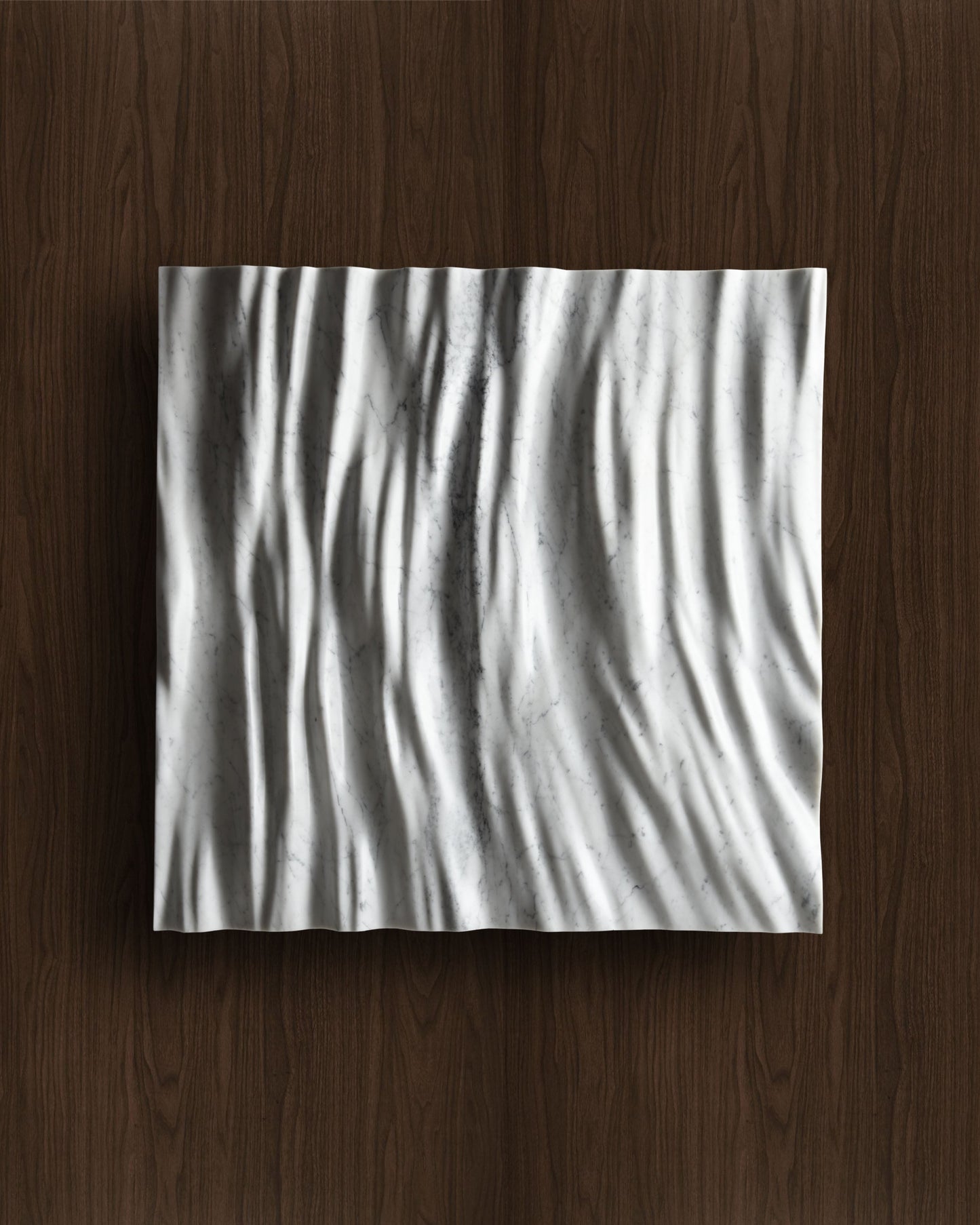 Eternal Carrara marble wall sculpture displayed on a warm walnut background