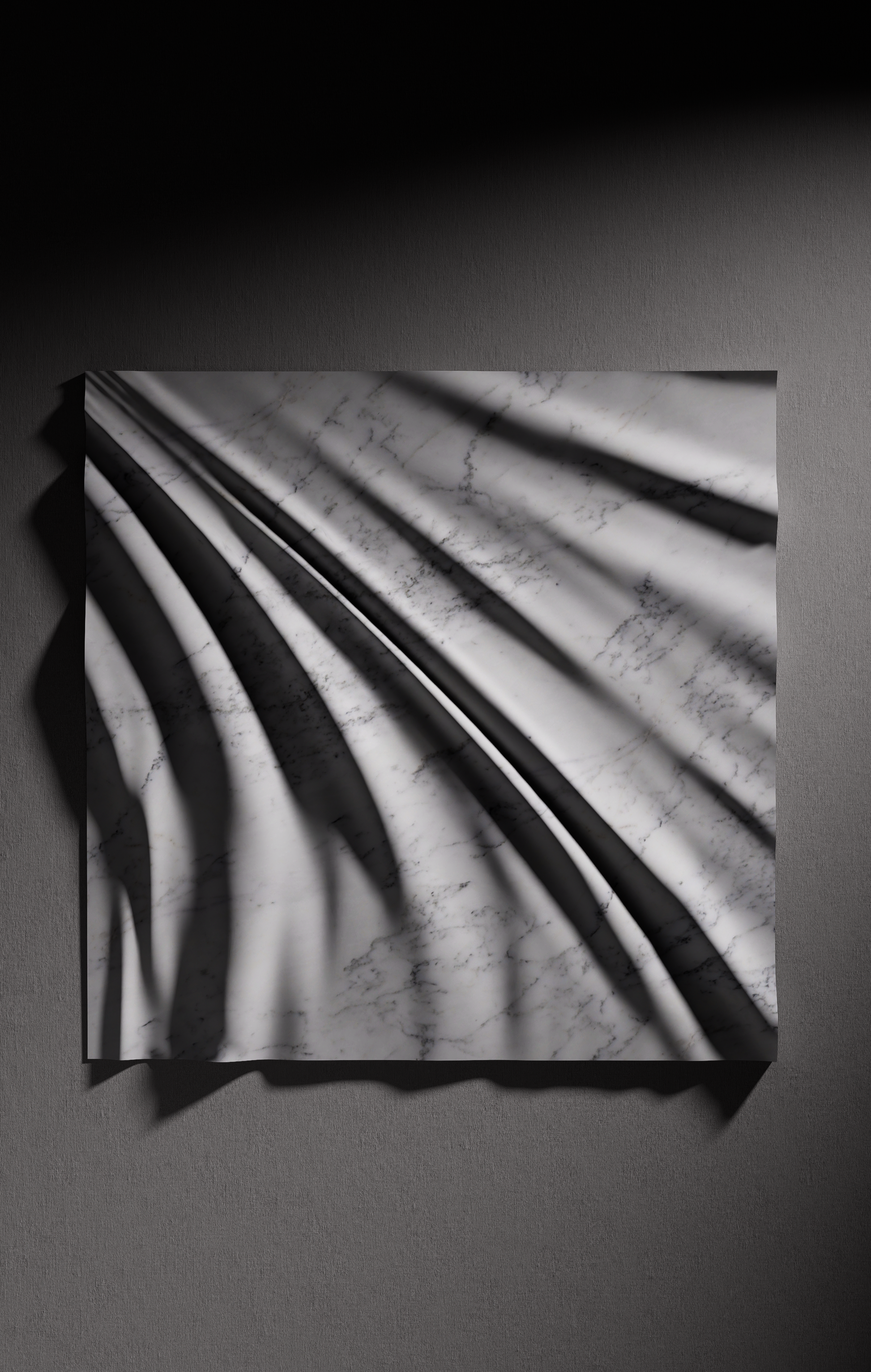 Close up of carved folds in Carrara marble showing light shadow contrast and natural veining