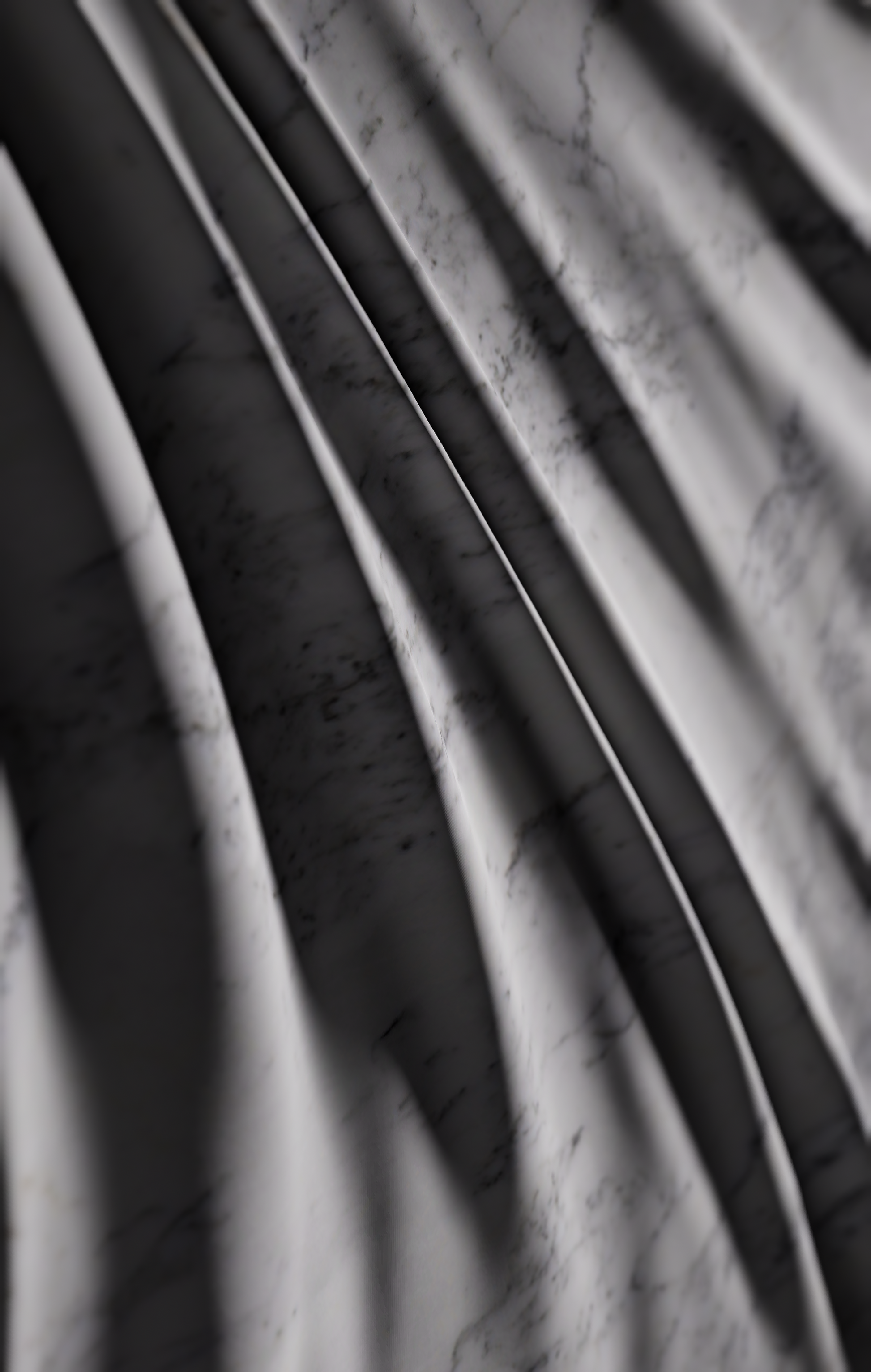 Angled view of square Carrara marble wall sculpture showing deep folds and sculpted edge