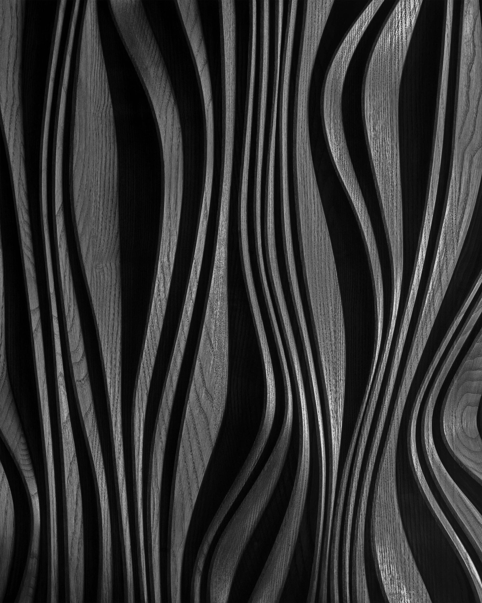 Close up of carved layered relief in black finish, texture detail