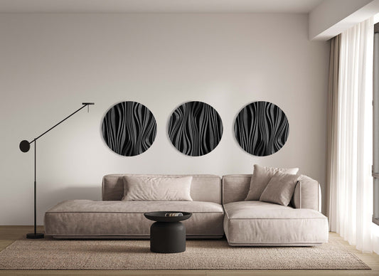 Three Forest black round sculptures installed above a sofa, interior view