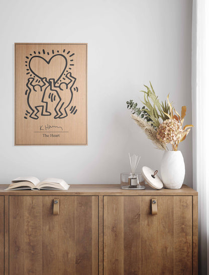 Stylish home office featuring a Kate Harring ‘The Heart’ wood panel, seamlessly uniting minimalist furniture and big wall decor elements.