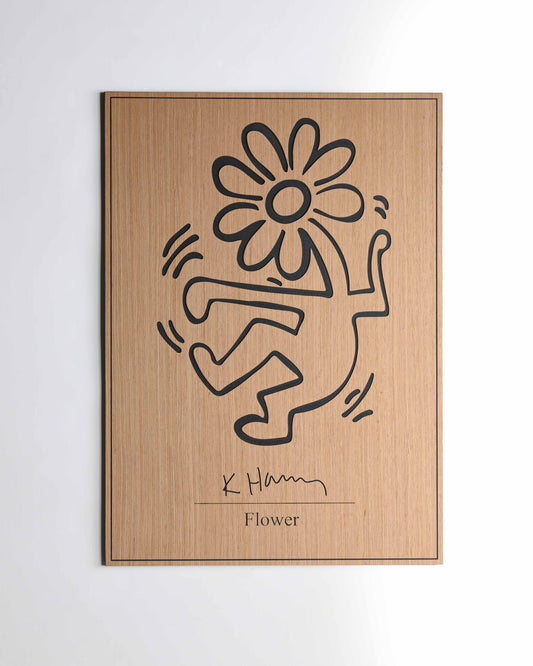 Close-up of the flower carving on a black-and-oak panel, highlighting precise petal lines and contrasting wood tones.