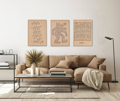 Three panel wall set inspired by Keith Haring in oak with black carved details, styled above a sofa