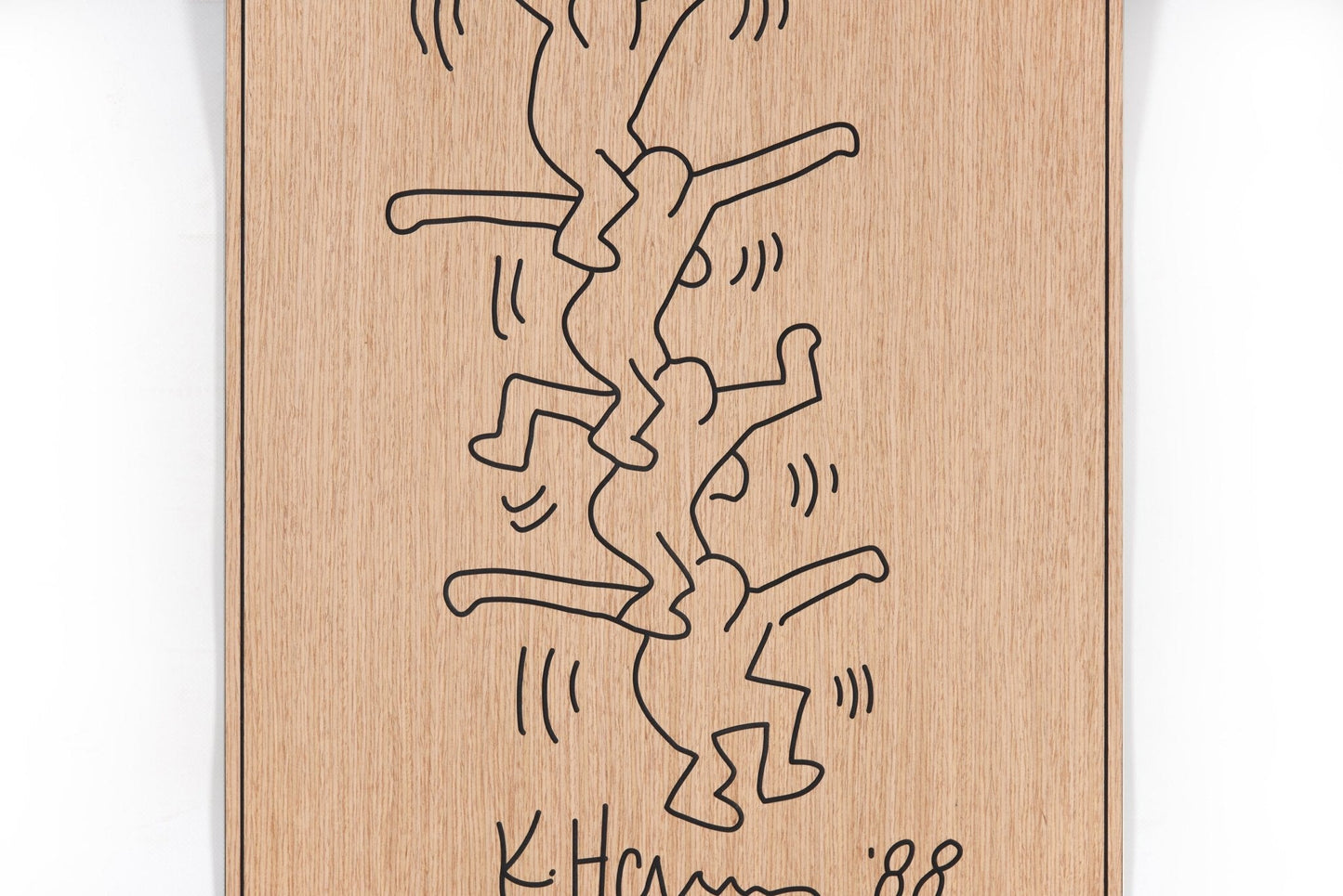 Front view of the acrobat panel with carved black lines on oak