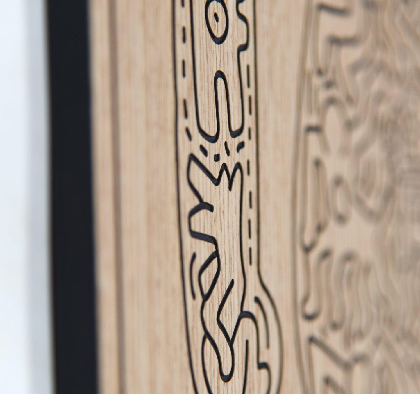 Close up of carved line detail on the dancer panel with oak grain in focus