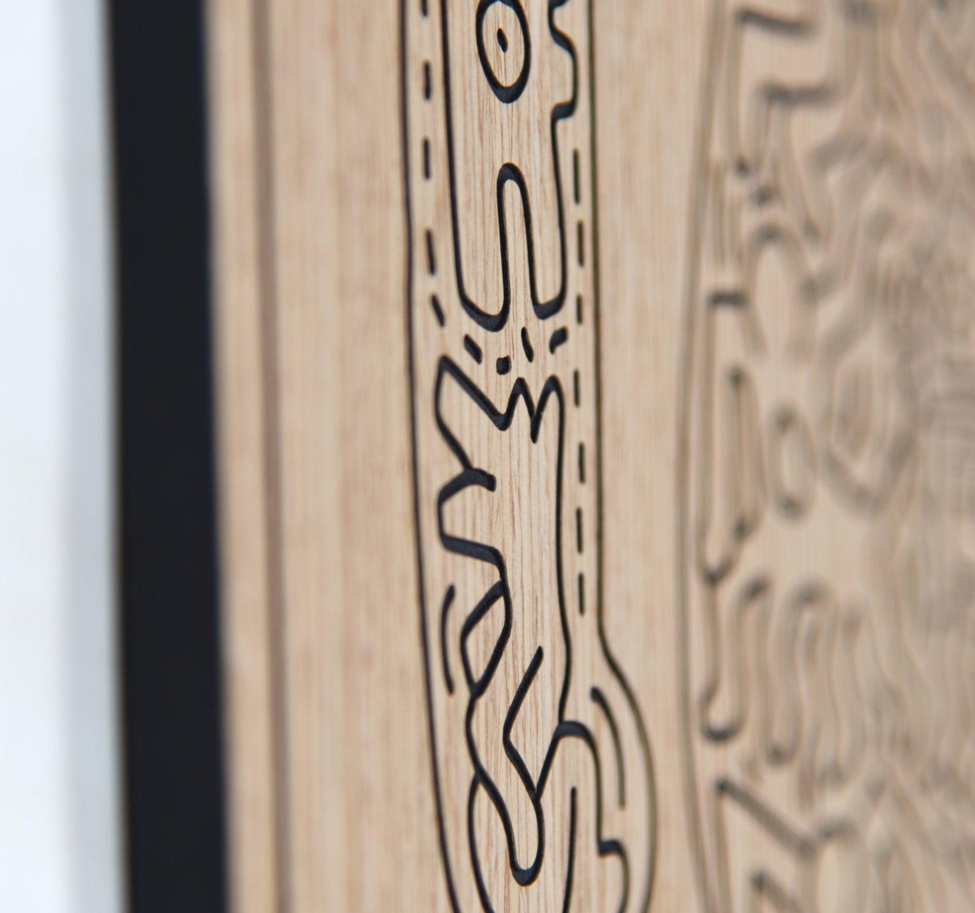 Close up of carved line detail on the dancer panel with oak grain in focus
