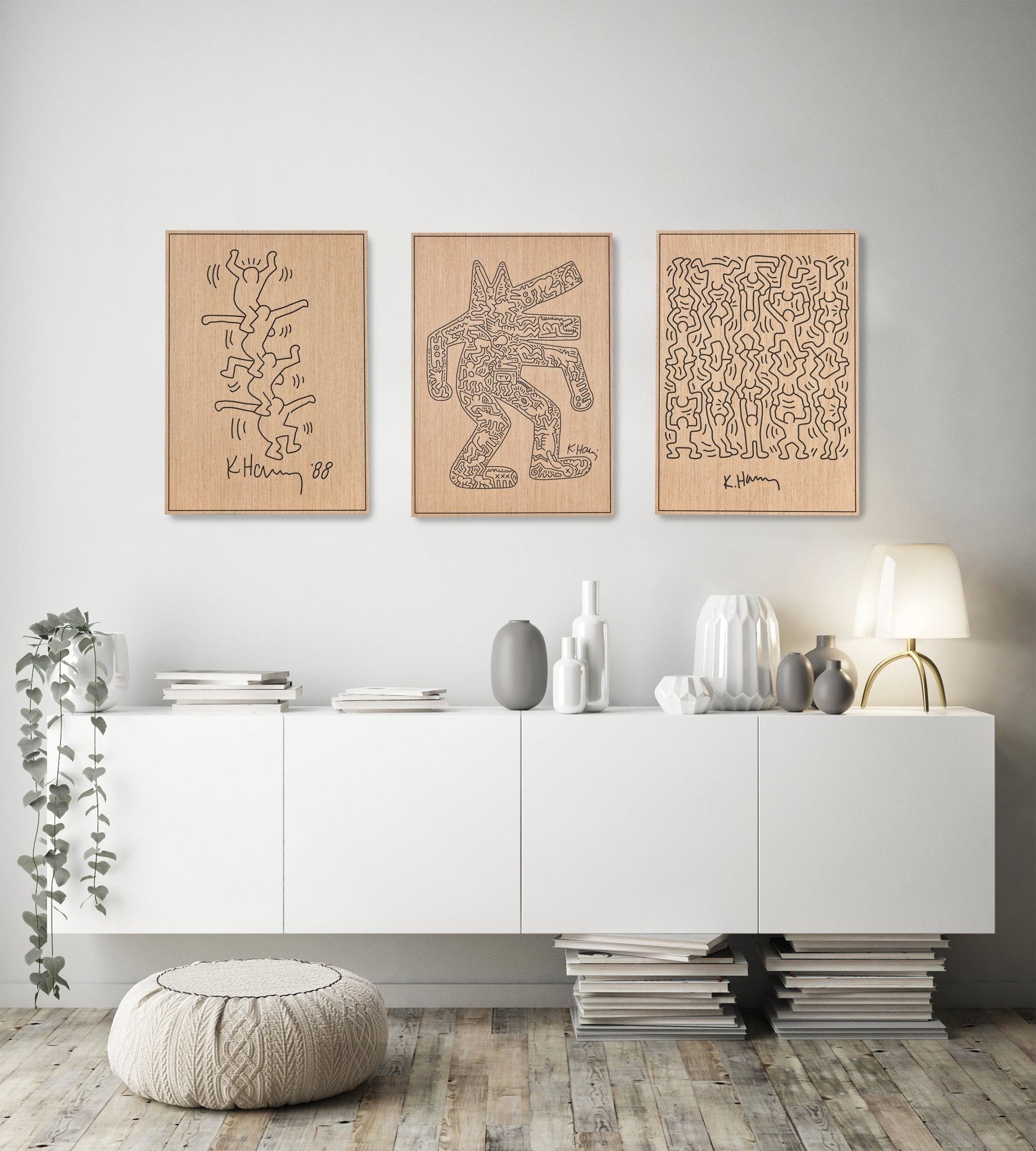 Three panel Keith Haring inspired set installed above a sideboard in a modern interior