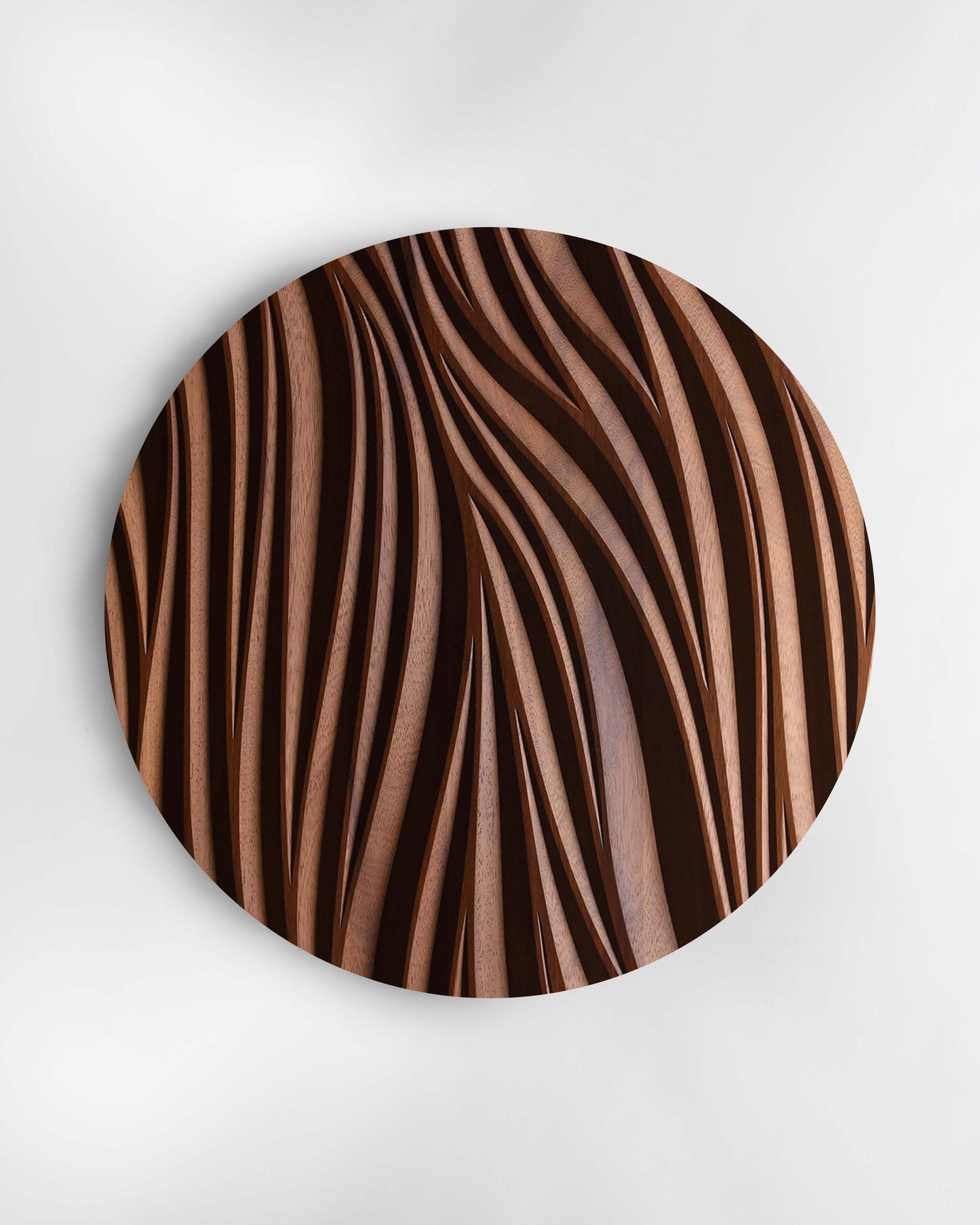 Leaf circular wall sculpture in iroko, front view on white background