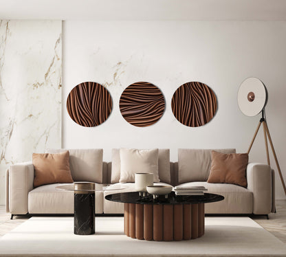 Three round Leaf iroko wall sculptures styled above a sofa with warm neutral tones