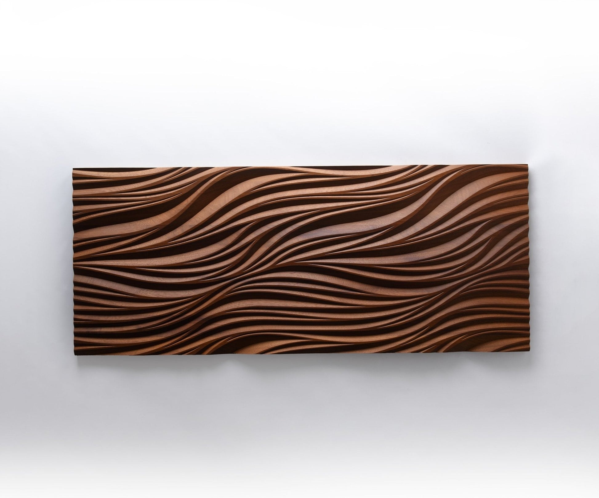 Detailed shot of leaves & nature motif, pairing wooden wall panels appeal with tactile geometric design in richly toned iroko.