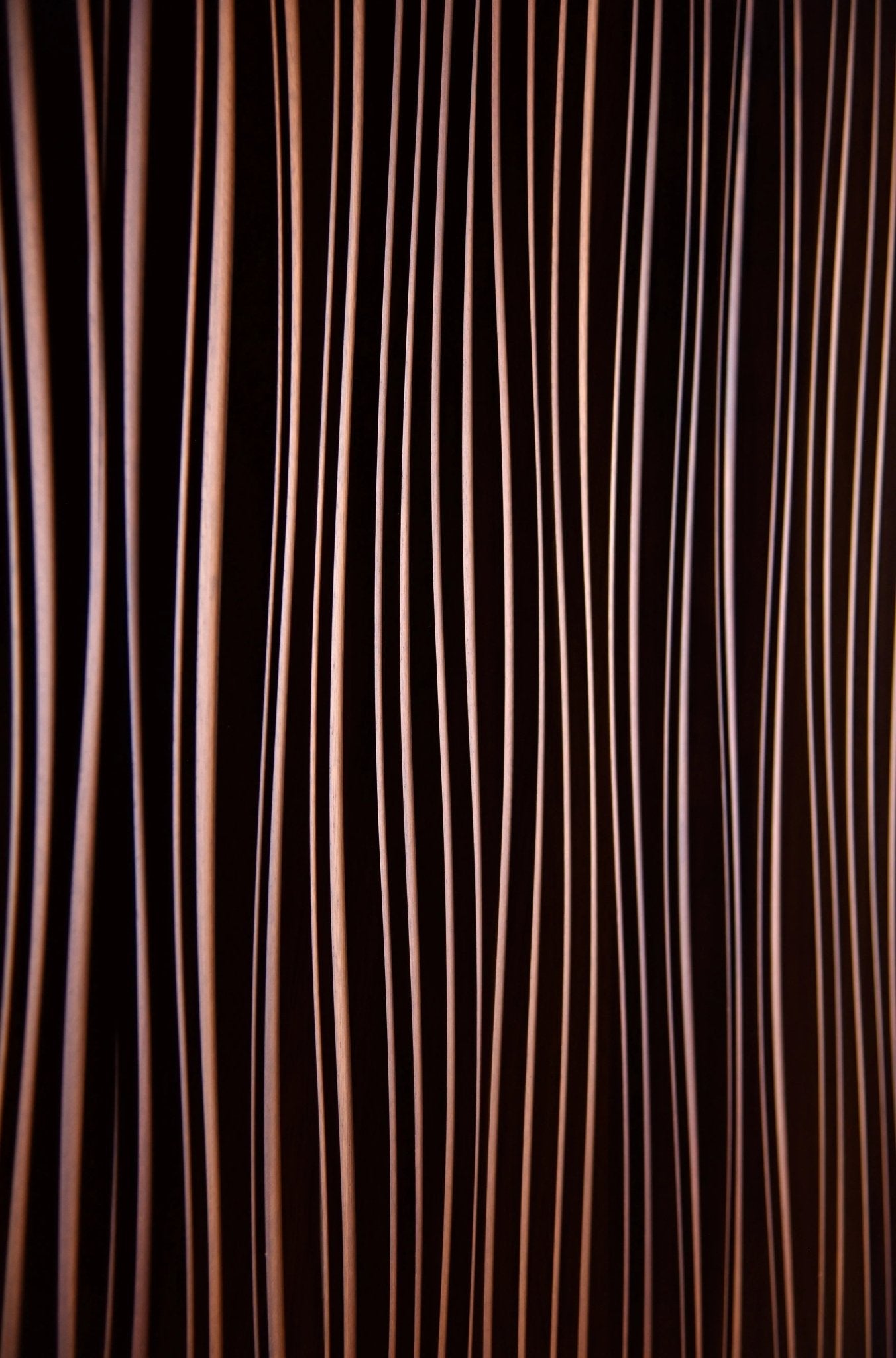 Close-up revealing slight color shifts in Iroko beneath fine line carvings, enhancing house design synergy and refined interior decoration style.