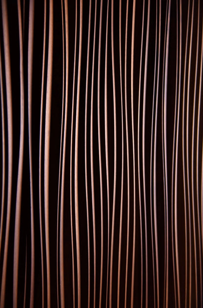 Close-up revealing slight color shifts in Iroko beneath fine line carvings, enhancing house design synergy and refined interior decoration style.