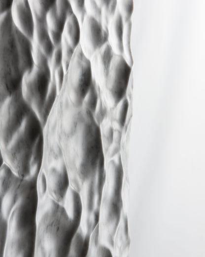 Side profile detail of the Liquid Marble sculpture showing thickness, texture and soft light