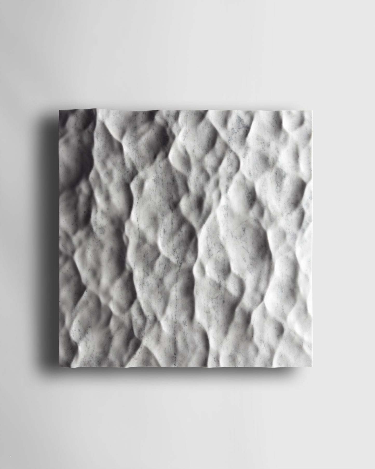 Liquid Marble Carrara wall sculpture front view with fluid carved relief and natural grey veining