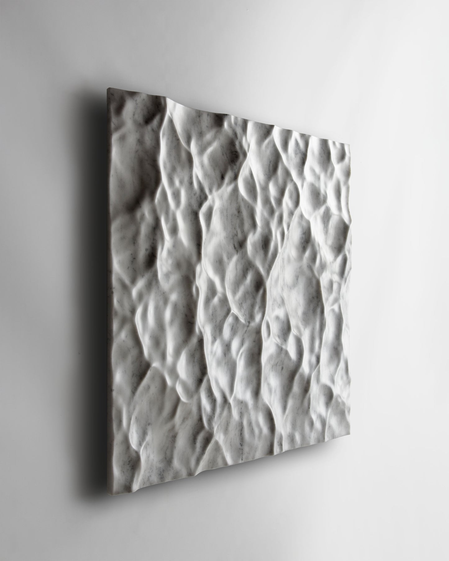 Perspective view of the Liquid Marble Carrara wall sculpture highlighting fluid movement across the surface