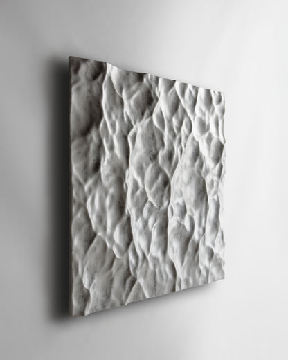 Perspective view of the Liquid Marble Carrara wall sculpture highlighting fluid movement across the surface