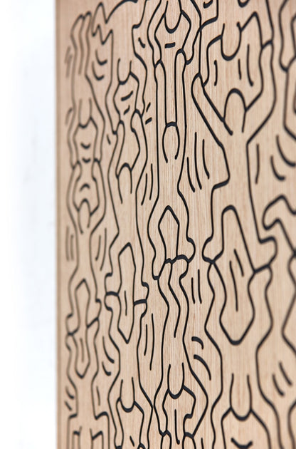 Little Men Keith Haring-inspired carved oak wall art, angled close-up of the black linework