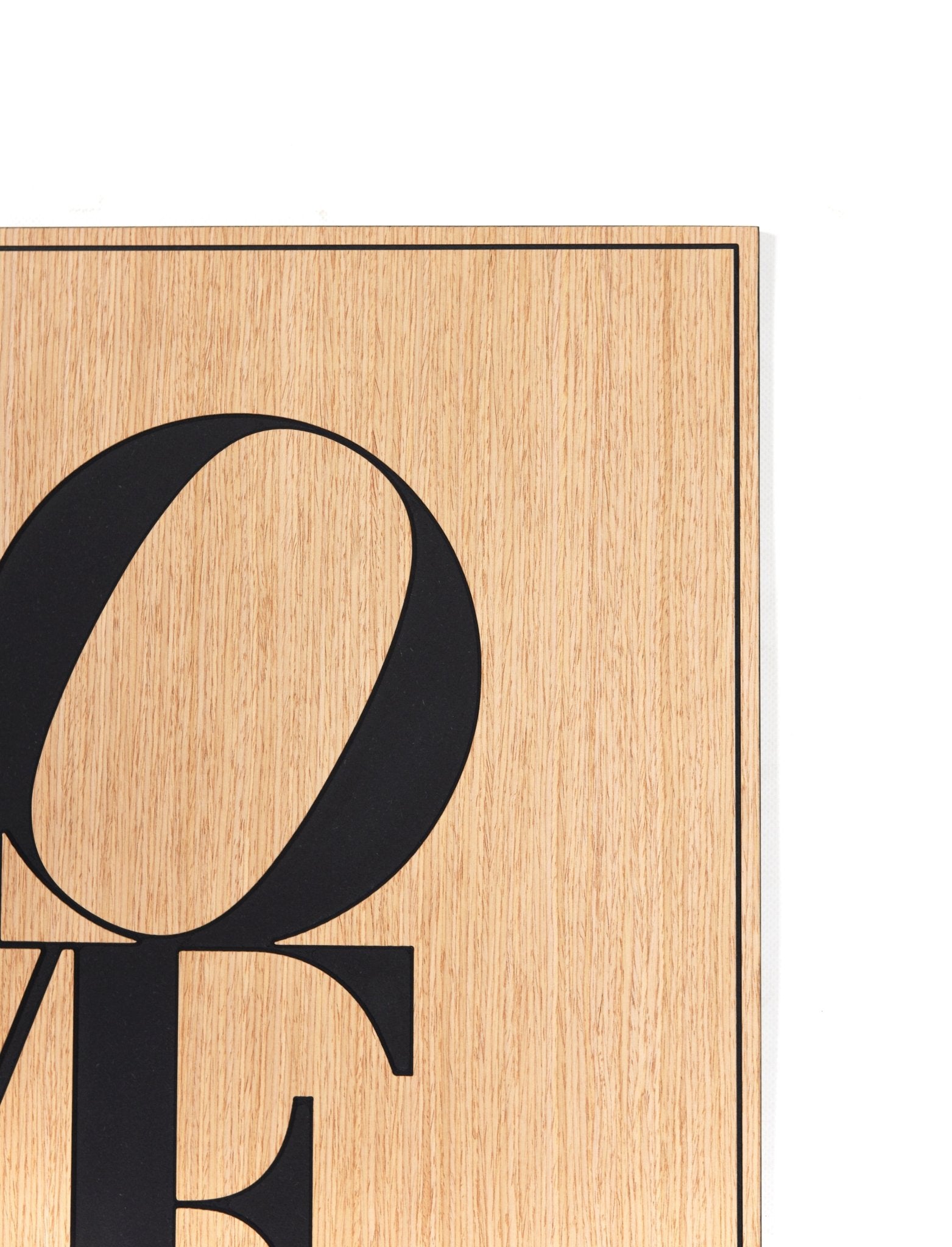 Corner detail of the Love oak wall art showing the fine border line and surface grain