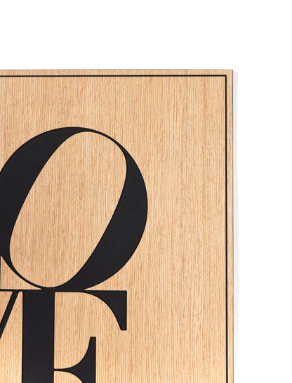 Corner detail of the Love oak wall art showing the fine border line and surface grain