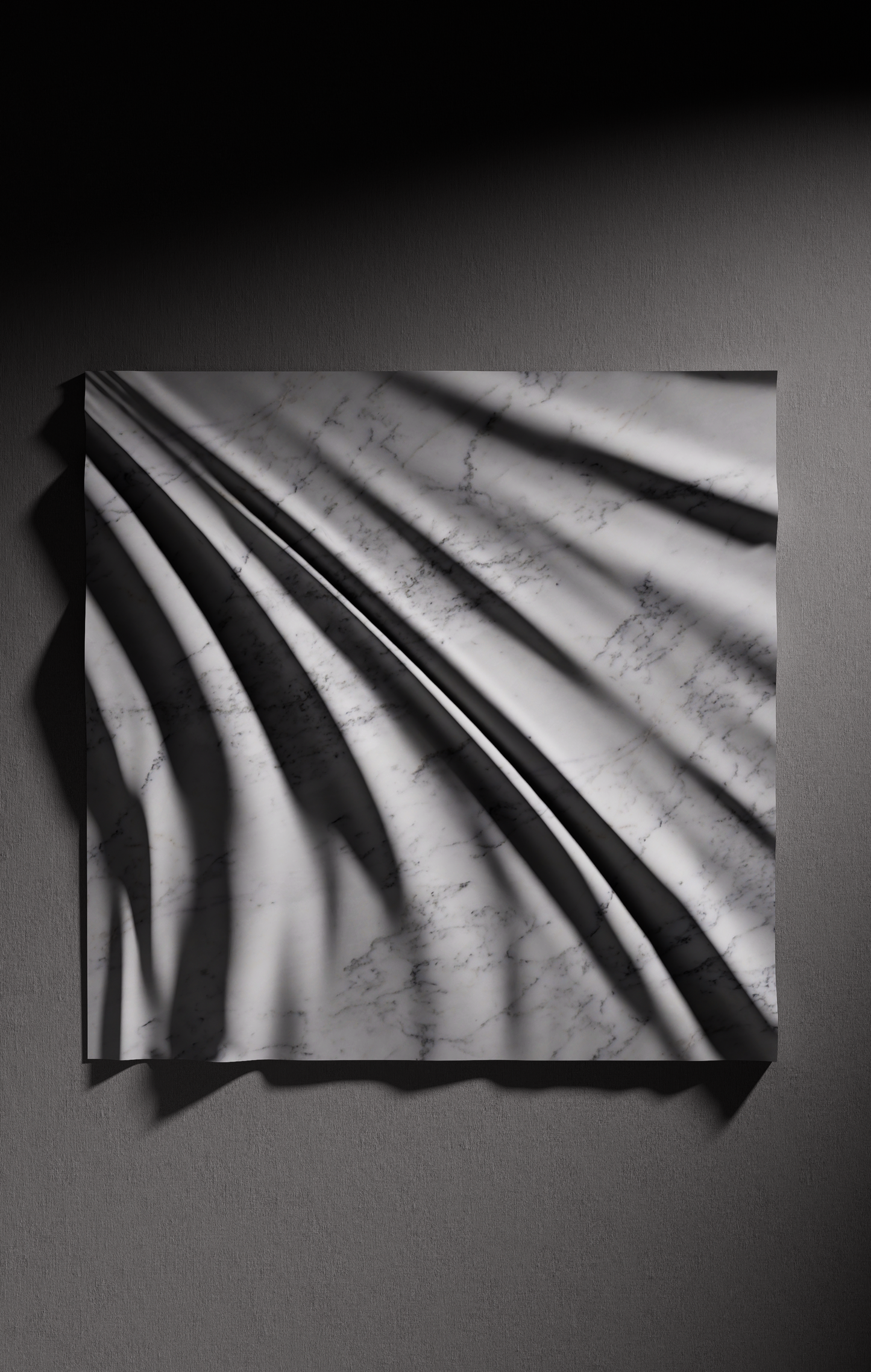 Close up of carved folds in Carrara marble showing light shadow contrast and natural veining