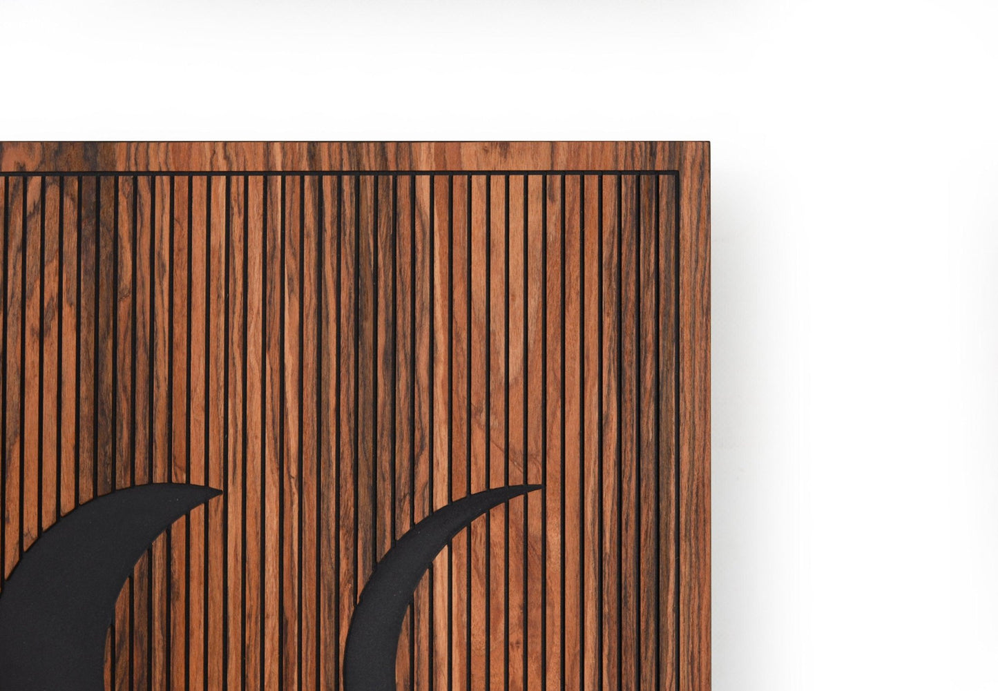 Corner detail of rosewood panel showing engraved vertical lines and frame