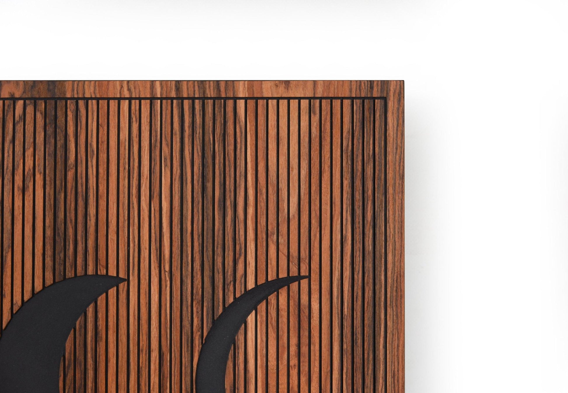 Corner detail of rosewood panel showing engraved vertical lines and frame
