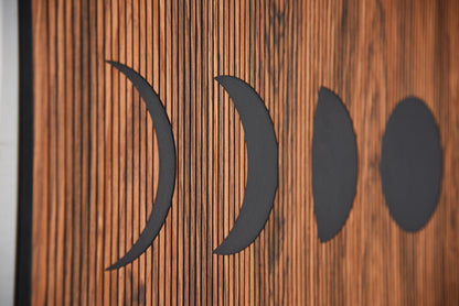 Close up of moon phases shapes on rosewood, engraved line texture detail