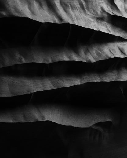 Close view of the carved mountain inspired relief and shadowed cavities of Mountain Echo Black
