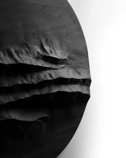 Angled edge detail of Mountain Echo Black showing deep carved ridges in black finished wood