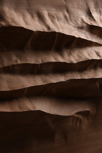 Close view of the carved mahogany ridges and shadowed valleys of Mountain Echo