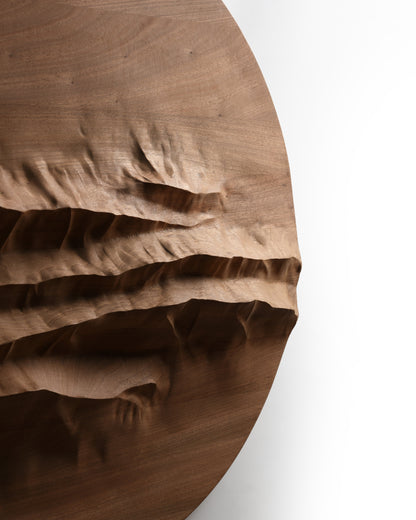Edge detail of Mountain Echo showing deep mountain inspired relief carved into mahogany